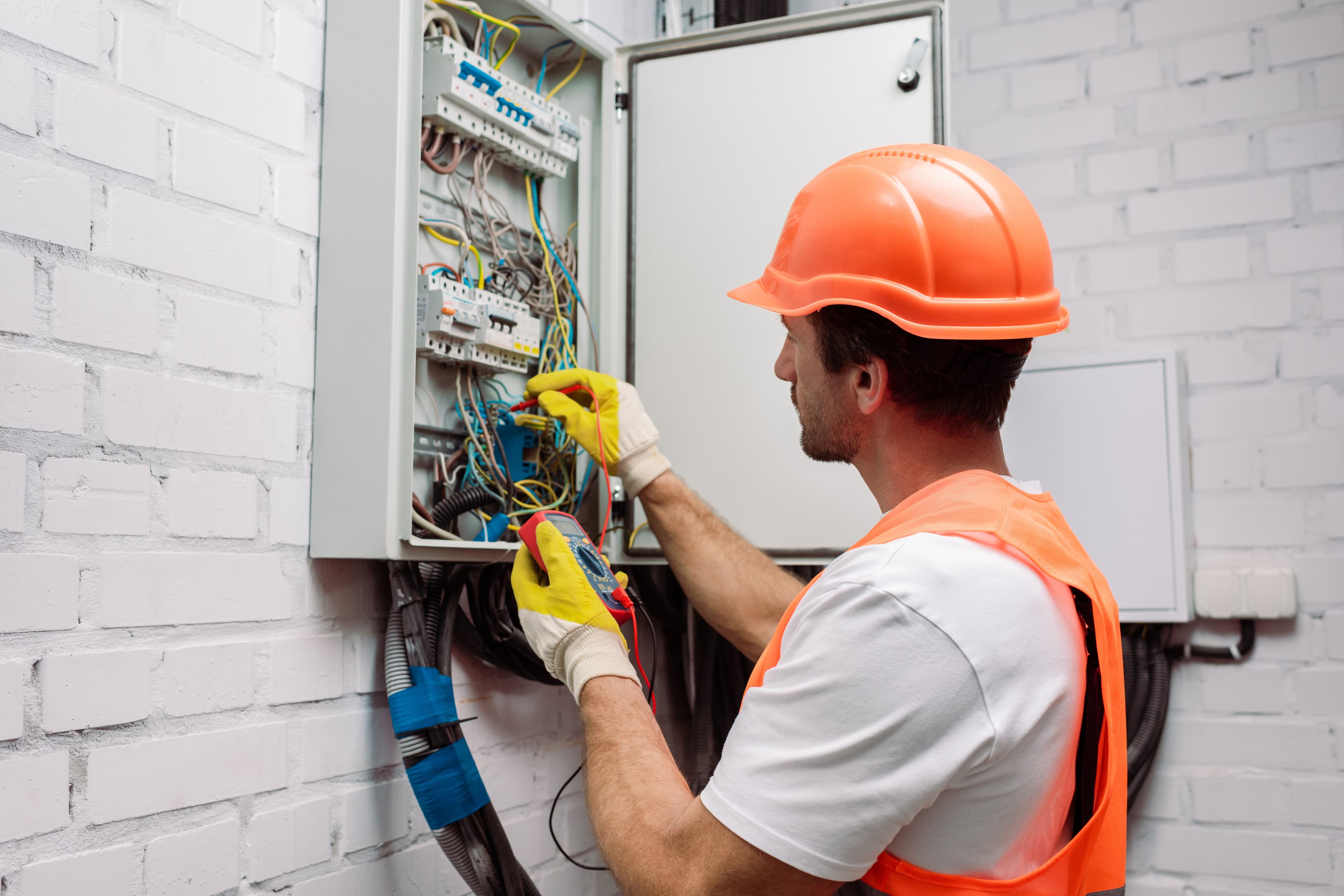 Electrician working on an electrical panel