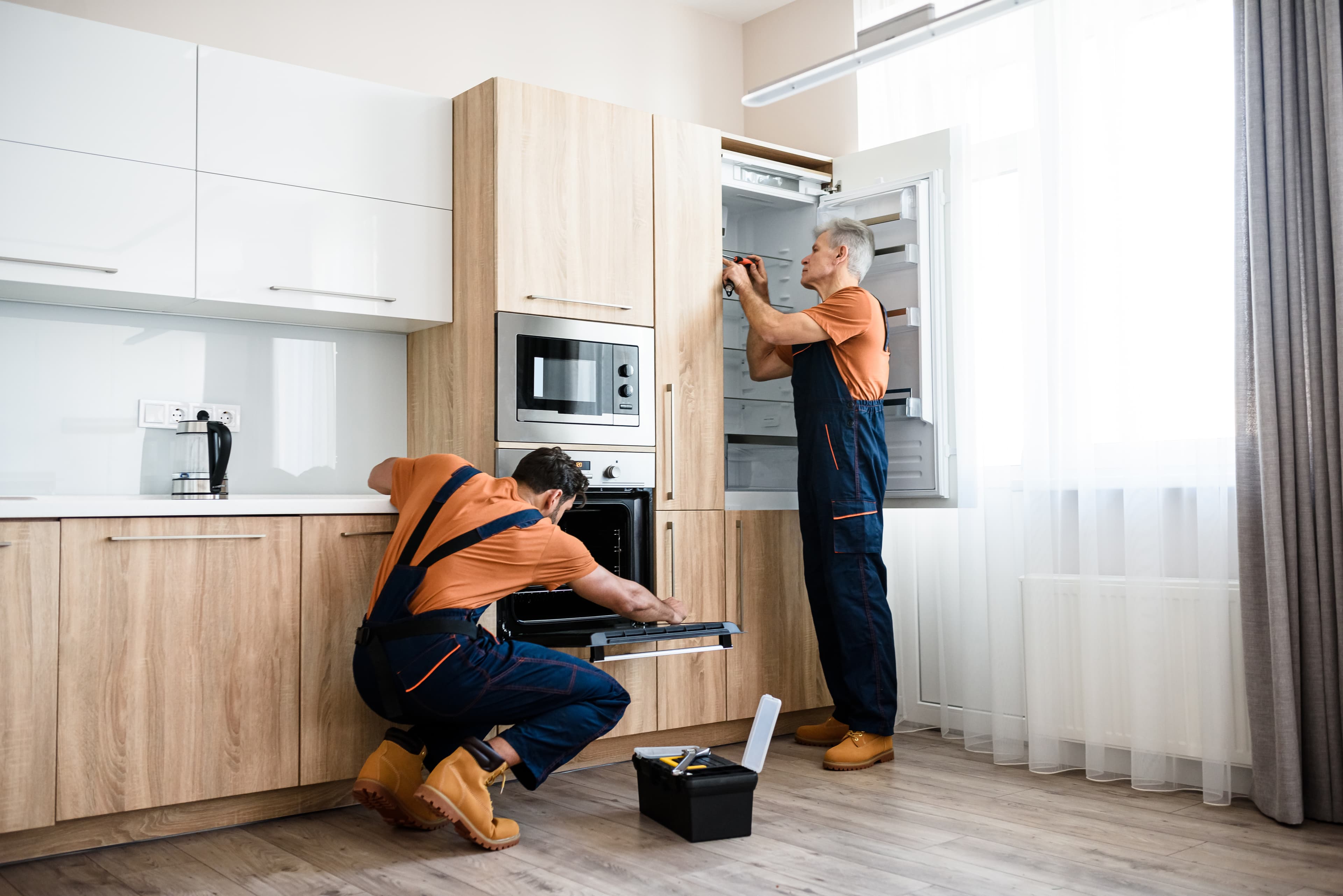 Kitchen fitters installing cabinets